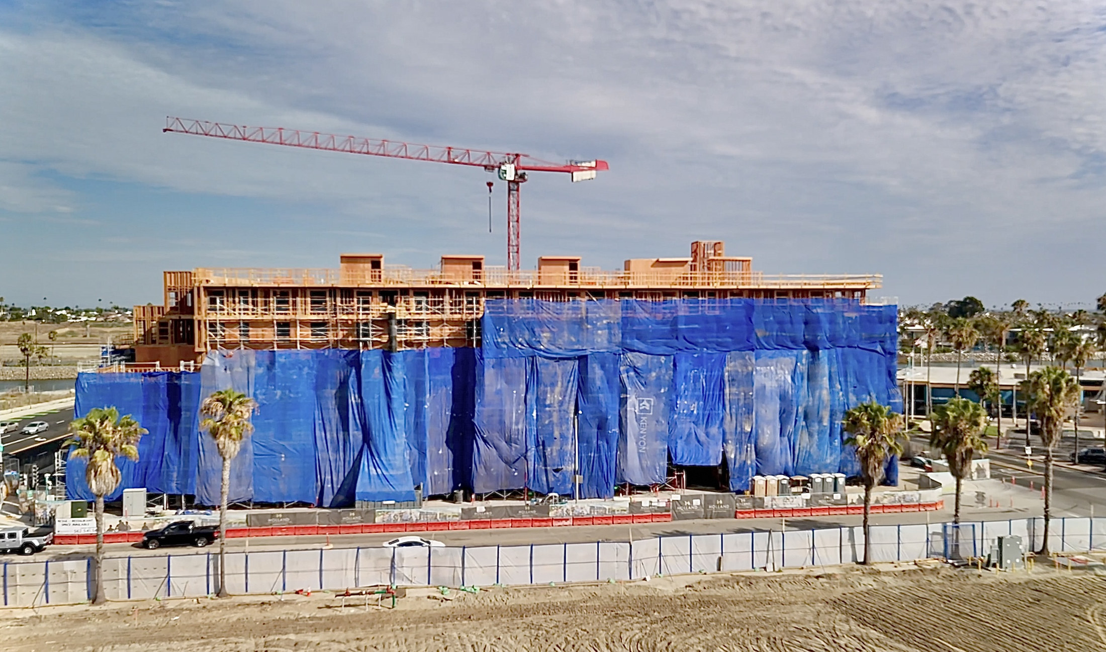 Congressional Place vertical construction wrapped in blue safety mesh